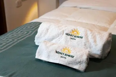 two towels sitting on top of a bed at Velvet Sunrise Hotel in Machu Picchu