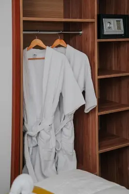 a closet with white shirts hanging in it at Velvet Sunrise Hotel in Machu Picchu