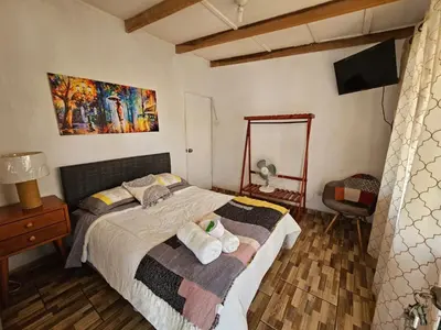 a bedroom with a bed with two towels on it at Hotel Nuestro Amo in Sayán