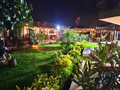 a garden at night with lights in the yard at Hotel Nuestro Amo in Sayán