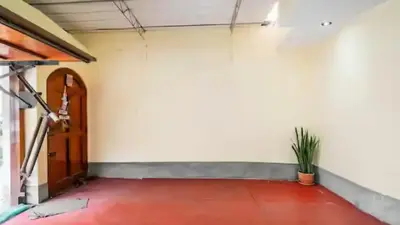an empty room with a door and a plant at Loft equipado y acogedor con Terraza en Matellini in Lima
