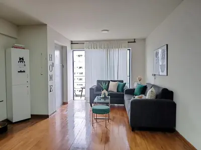 a living room with a couch and a table at Habitación Pequeña dentro departamento compartido 402 in Lima
