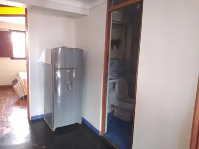a kitchen with a stainless steel refrigerator in a room at El despertar del inka in Cusco