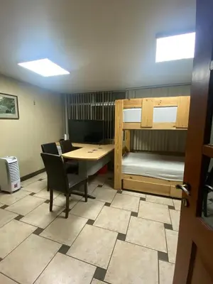 a room with a desk and a table and bunk beds at Mini Supercentrico in Lima