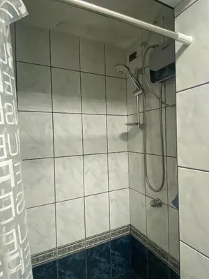 a shower in a bathroom with a glass door at Mini Supercentrico in Lima