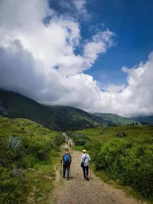 two people walking down a dirt road at Hotel Tambo del Inca in Cajatambo