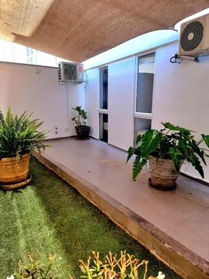 a patio of a building with potted plants at Aqua y Sol Private Pool Parking Air Conditioning in Playa de Santa María