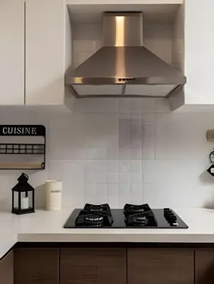 a kitchen with a stove top and a hood at Artline Terrace Residence in Lima