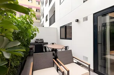 a balcony with chairs and a table on a building at Artline Terrace Residence in Lima