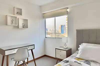 a bedroom with a desk and a bed with a window at Big 3BR Apartment in the center of Miraflores in Lima