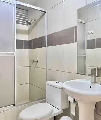 a bathroom with a white toilet and a sink at Big 3BR Apartment in the center of Miraflores in Lima
