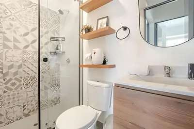 a bathroom with a toilet and a sink and a mirror at Contemporary Great View in Lima