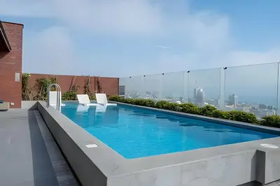 a swimming pool on the roof of a building at Contemporary Great View in Lima
