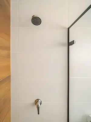 a shower with a glass door with a drain at Exclusive Apartment in Miraflores in Lima