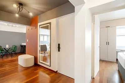 an open living room with a white door and a table at Exclusive Apartment in Miraflores in Lima