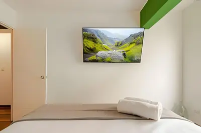 a bedroom with a bed with a picture on the wall at Exclusive Apartment in Miraflores in Lima