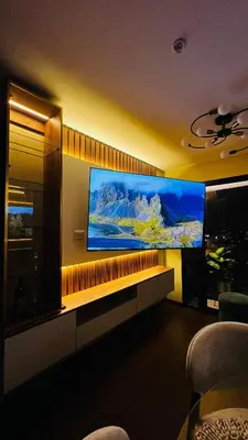 a living room with a large flat screen tv on a wall at Piso 25 con vista panorámica in Lima