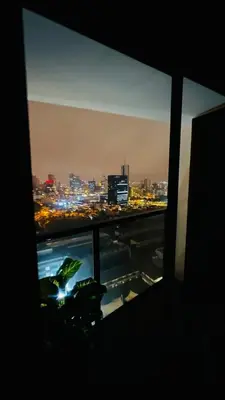a view of a city at night from a window at Piso 25 con vista panorámica in Lima