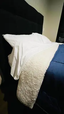 a bed with white sheets and pillows on it at Piso 25 con vista panorámica in Lima