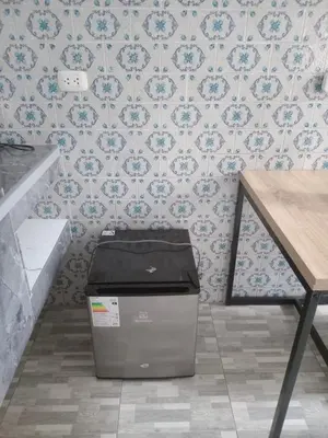 a room with a trash can in front of a wall at Habitación Estandar con baño privado en Monterrico Sur in Lima