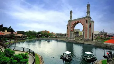 a waterway with boats in it in front of an arch at Habitación Estandar con baño privado en Monterrico Sur in Lima