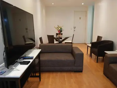 a living room with a tv and a couch and a table at Apartment in the center of Miraflores in Lima