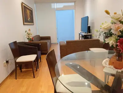 a living room with a glass table and a couch at Apartment in the center of Miraflores in Lima