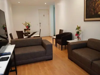 a living room with a couch and a table and chairs at Apartment in the center of Miraflores in Lima