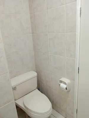 a bathroom with a toilet and a toilet paper dispenser at Apartment in the center of Miraflores in Lima