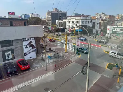a city street with cars parked on the road at LimaViva A in Lima