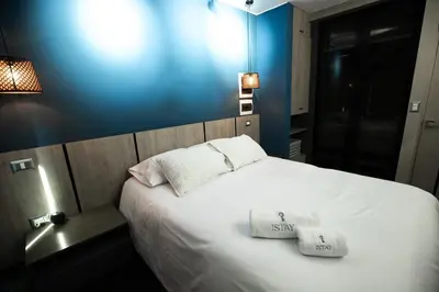 a bedroom with a white bed with two towels on it at iStay 1bed 1Bathroom Urban Deluxe in Lima