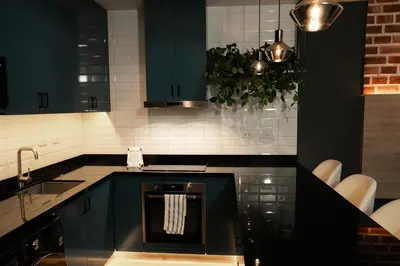 a kitchen with dark blue cabinets and a sink at iStay 1bed 1Bathroom Urban Deluxe in Lima