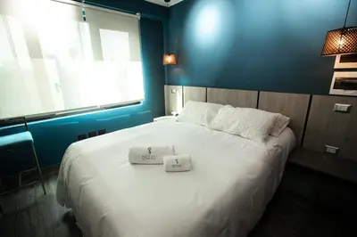 a bedroom with a large bed with two towels on it at iStay 1bed 1Bathroom Urban Deluxe in Lima