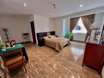 a bedroom with a dog laying on a bed at Casa Cubo Deluxe in La Molina in Lima