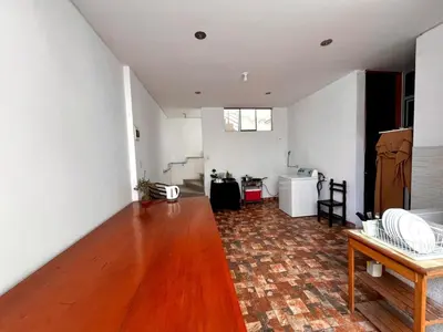 a living room with a wooden floor and white walls at Casa Cubo Deluxe in La Molina in Lima