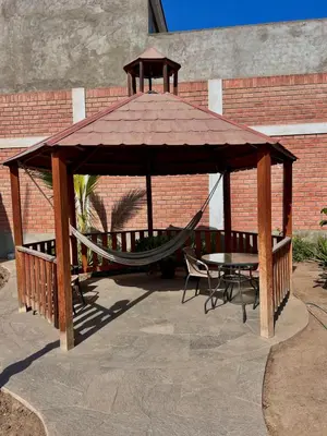 a gazebo with a hammock and a table at Casa Cubo Deluxe in La Molina in Lima