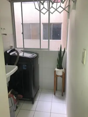 a bathroom with a toilet and a sink and a window at Departamento Condominio Club Carabayllo in Carabayllo