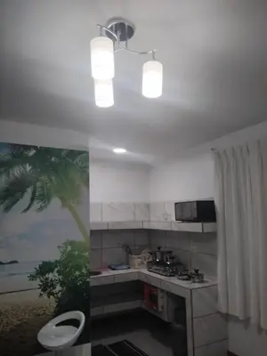 a kitchen with a sink and a stove at Habitación acogedora in Lima
