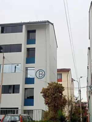 a b logo on the side of a building at H&H home in Cusco