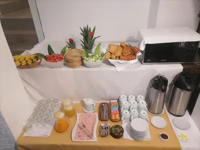 a table with food and a microwave on a shelf at Hoteles Romero in Machu Picchu