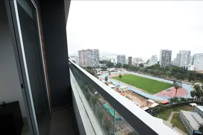 a view of a city from the balcony of a building at iStay Encantador Loft Piscina BBQ Gym Bicicleta in Lima