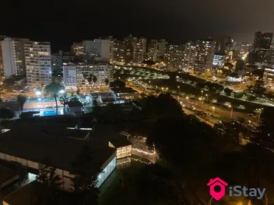 a view of a city at night with lights at iStay Encantador Loft Piscina BBQ Gym Bicicleta in Lima