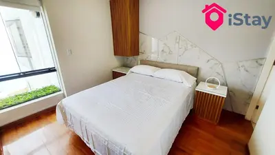 a bedroom with a white bed and a window at iStay Espectacular Vista Mar Miraflores in Lima