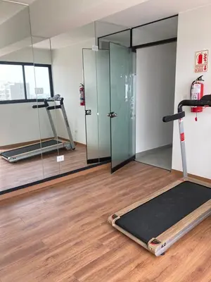 a gym with a treadmill and a mirror at iStay Santuario Linsidro Cerca Hospitales Gym in Lima
