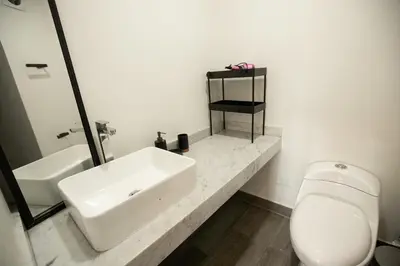 a white bathroom with a sink and a toilet at iStay Nuevo 2D 2B Balcón in Lima