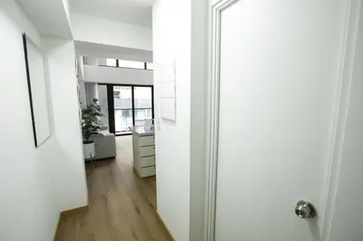 a hallway with a white door and a white dresser at Mezanine Deluxe Miraflores in Lima