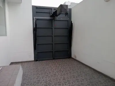 a garage with a garage door open and a tile floor at Super departamento en el centro de Miraflores in Lima