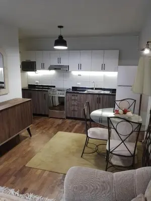 a kitchen with a table and chairs in a room at Miraflores, Lima, apartamento 1 dormitorio in Lima