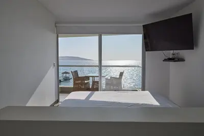 a bedroom with a bed and a view of the ocean at PARACAS Sotavento T2 401 in Paracas