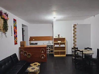 a living room with a couch and a table at Chakanas House in Cusco